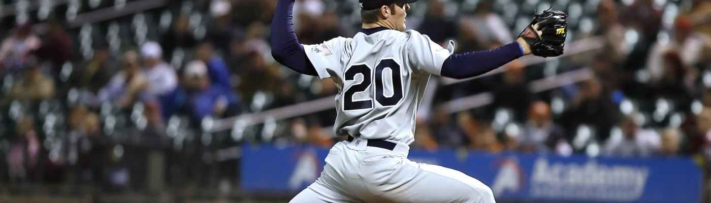 Baseball pitcher throwing at home plate