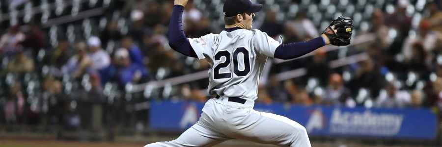 Baseball pitcher throwing at home plate