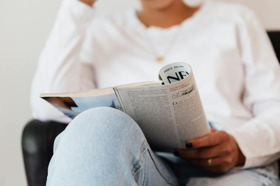 Woman reading a magazine article in the New Yorker