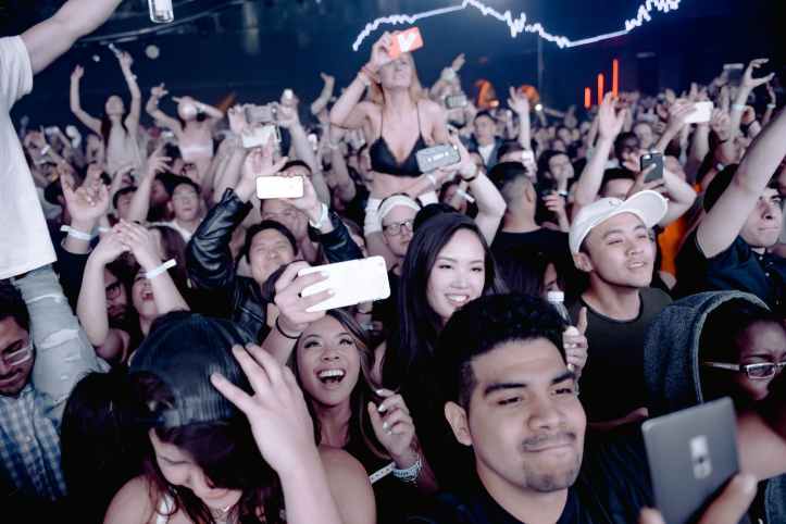 People holding smartphones at a concert
