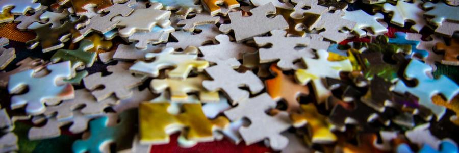 Colorful pieces of a jigsaw puzzle in a pile