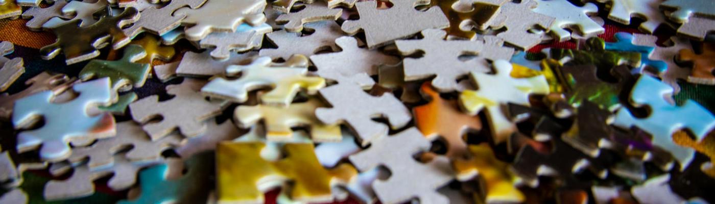 Colorful pieces of a jigsaw puzzle in a pile